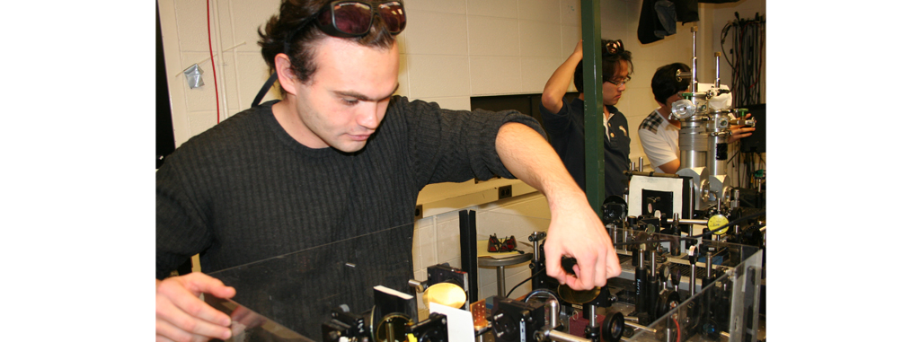 A person adjusting a device in a lab